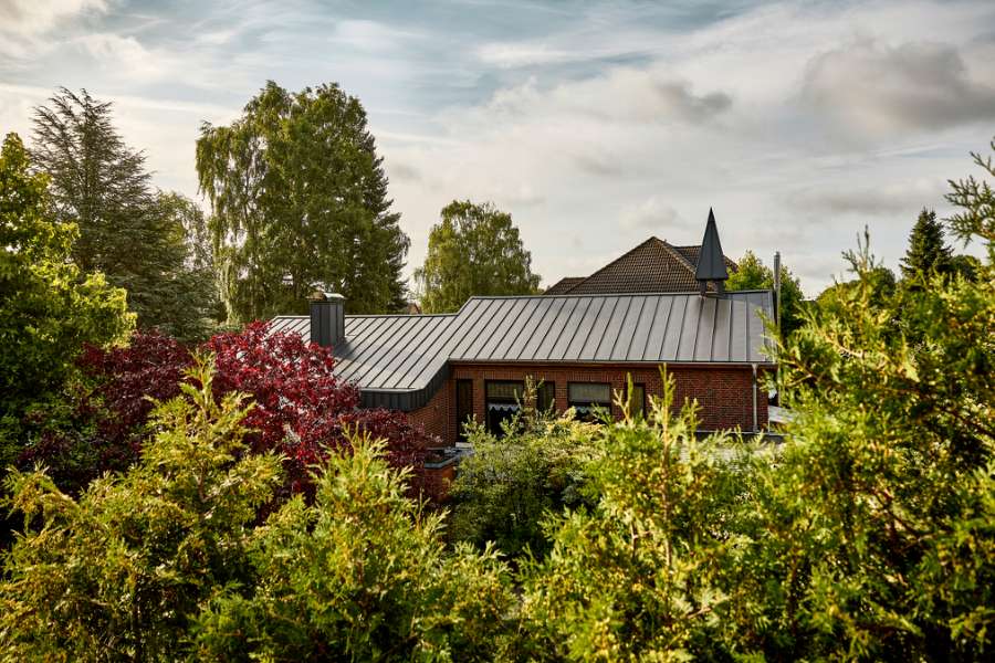 Klassisches, rotes Backsteinhaus in Bad Bodenteich, Deutschland, hat ein neues Stahldach und eine Stahlspirale erhalten